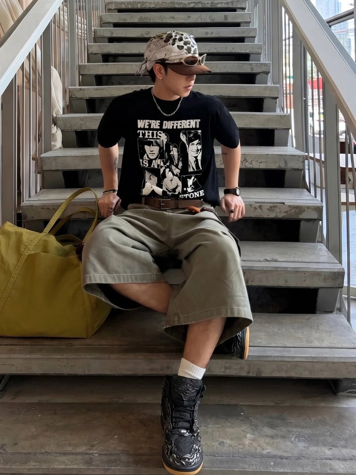 Male streetwear outfit featuring Wukong cloud relief black and silver high-top sneakers on concrete stairs