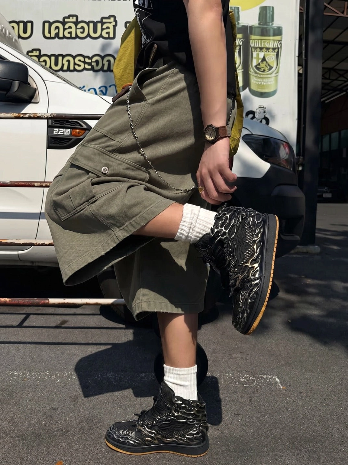 Wukong cloud relief black and silver high-top sneakers worn outdoors with olive cargo shorts and white crew socks