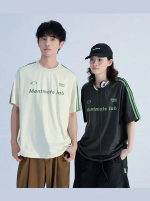 Black contrast stripe streetwear T-shirt styled on models with green sleeve details and chest lettering