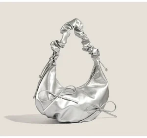 Metallic silver Y2K bow ruched hobo shoulder bag front three quarter view with scrunchie strap