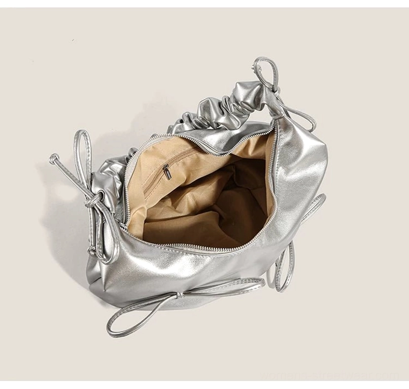 Open interior view of metallic silver Y2K bow hobo bag with polyester lining and zippered compartment