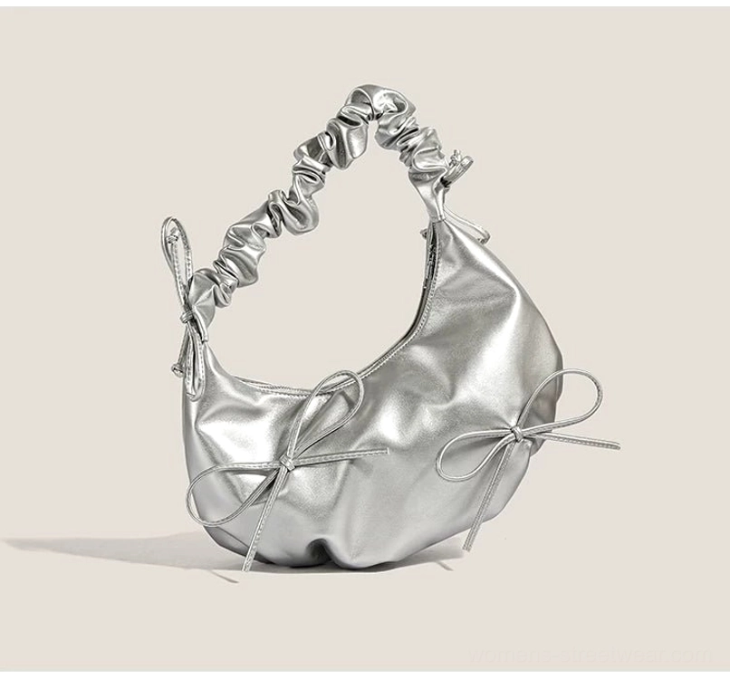 Front view of metallic silver Y2K hobo shoulder bag with two ribbon bows and ruched strap