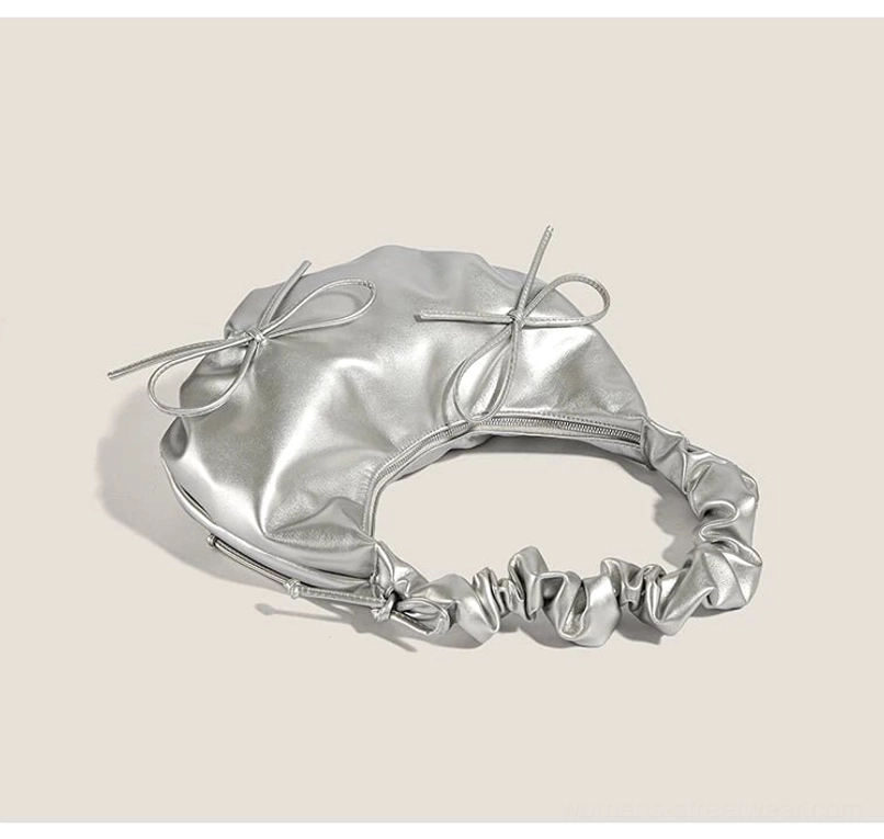 Top view of metallic silver Y2K ruched hobo bag showing zipper closure shoulder strap and bow details