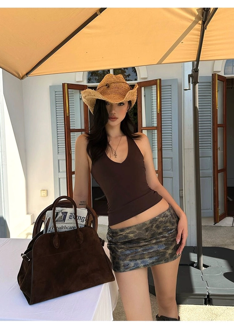 Y2K brown leopard sequin mini skirt styled with cropped brown tank top cowboy hat and tote bag