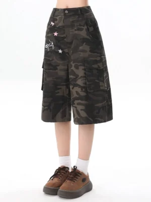 Front view of dark camouflage high waisted cargo culottes with star bow cartoon patches and wide leg silhouette