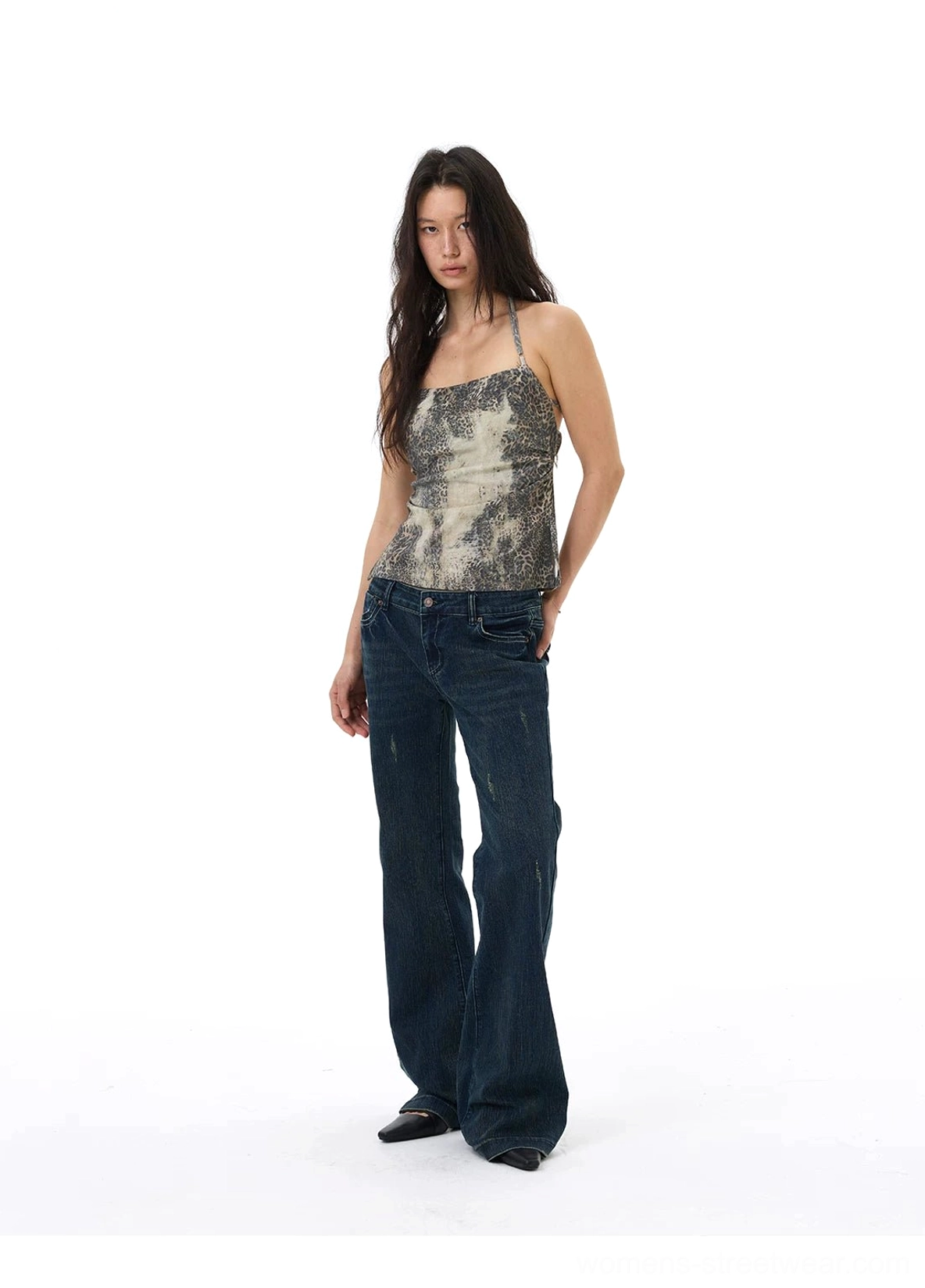 Side three-quarter view of a faded desert mirage print halter cami top with slim fitted streetwear silhouette