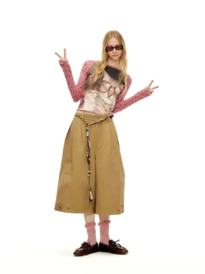 Pink polka dot mesh sleeve cat graphic cropped baby tee styled with tan cargo midi skirt