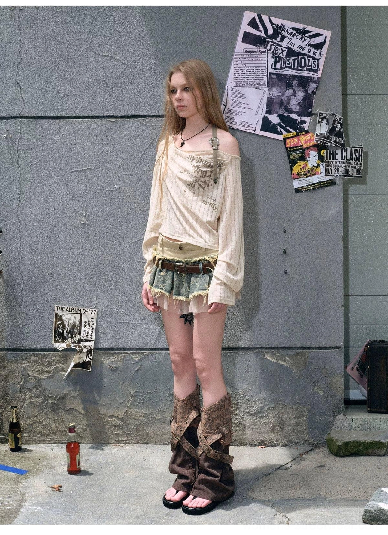Y2K inspired distressed denim mini skirt with patchwork texture, tulle layering, vintage metal buckle, and rebellious streetwear style