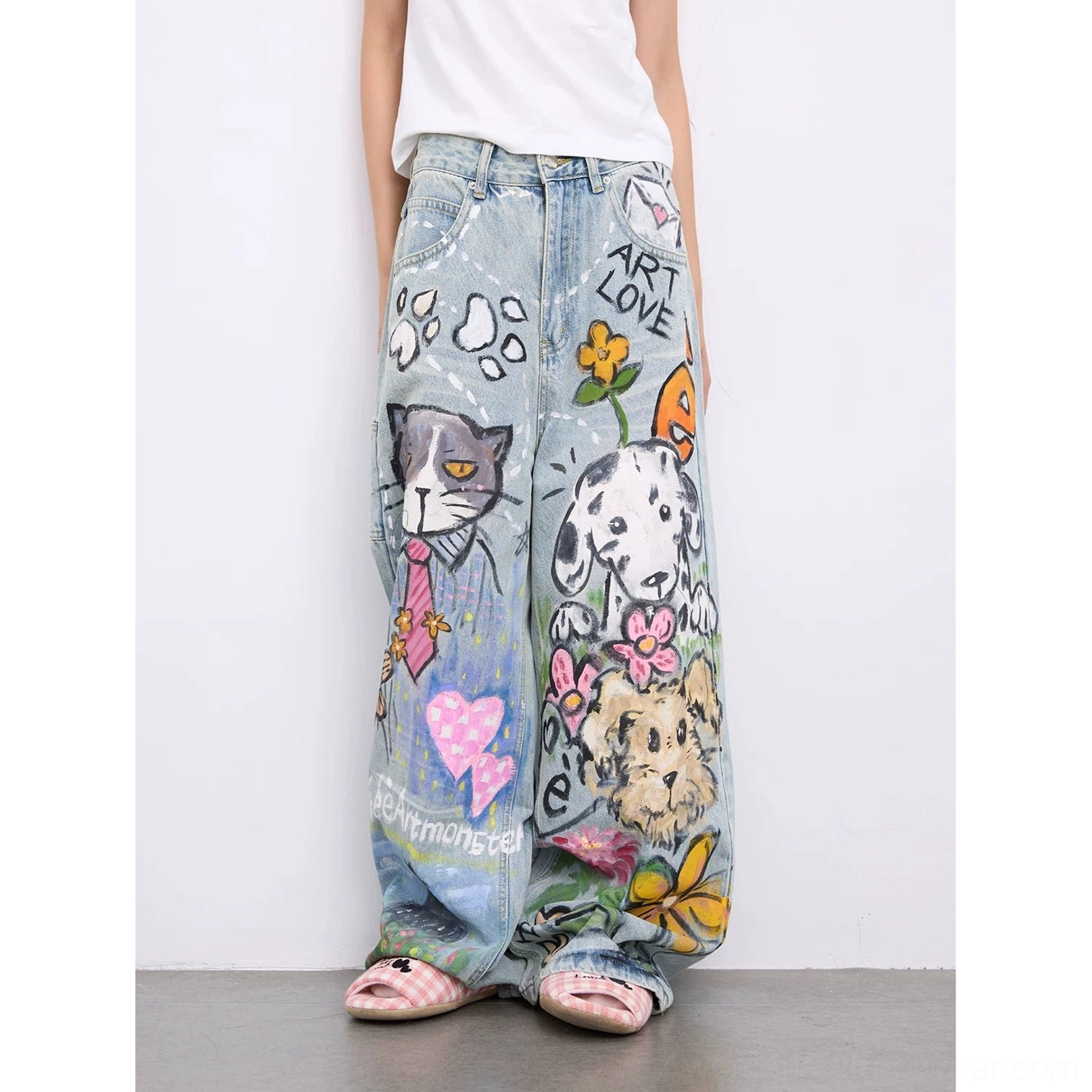 Front side view of women wearing light blue Y2K graffiti straight-leg jeans with hand-drawn cat dog flower heart and ART LOVE doodle graphics