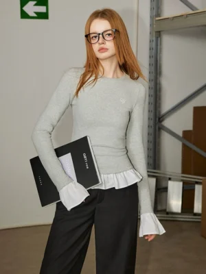 Flower Gray faux two-piece ruffle long sleeve streetwear top shown from a front three-quarter angle with blue contrast trim and embroidered chest detail