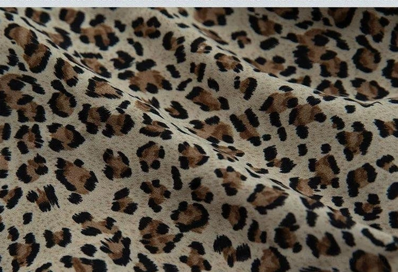Close-up of brown and black leopard print semi-sheer fabric for Y2K lace-trim camisole
