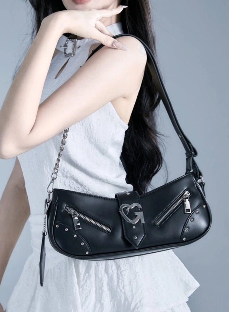 Black Y2K multi-zip baguette shoulder bag with silver buckle, chain strap, and multiple zipper details