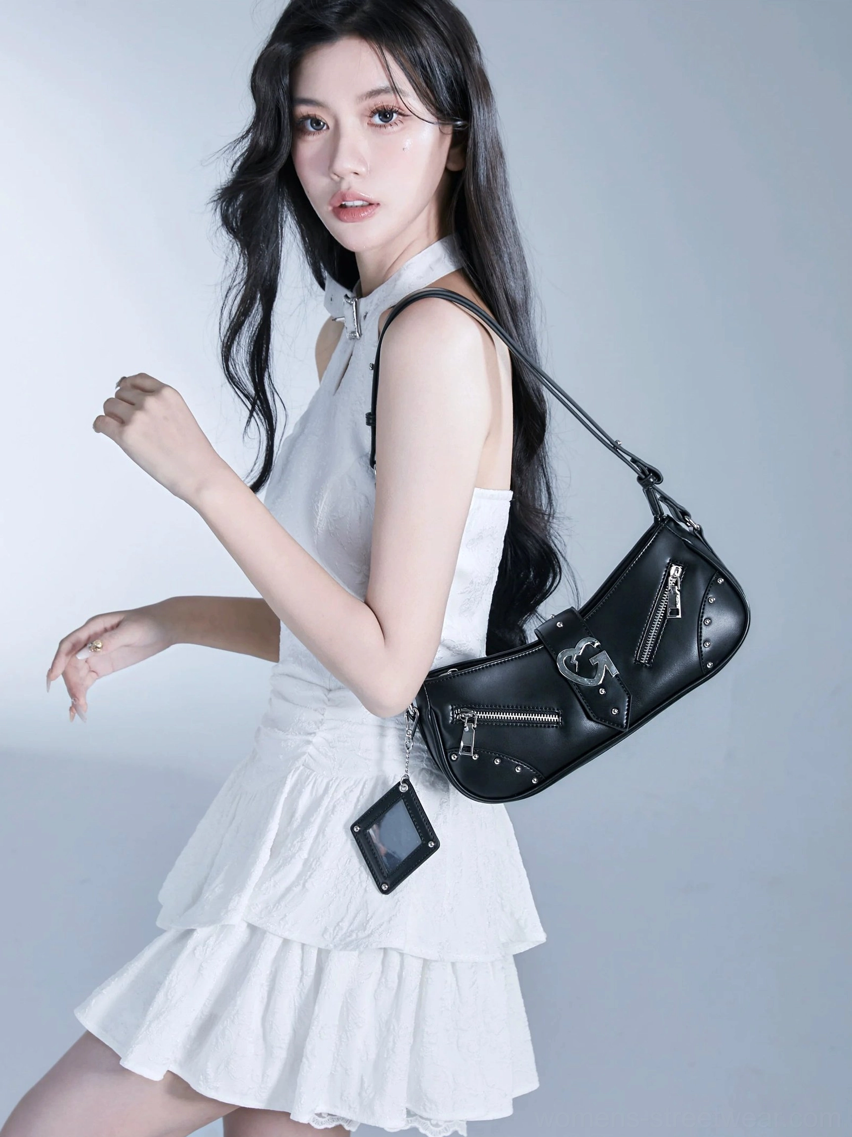 Black Y2K underarm baguette bag with hybrid chain and shoulder strap, silver hardware, and hanging tag accessory