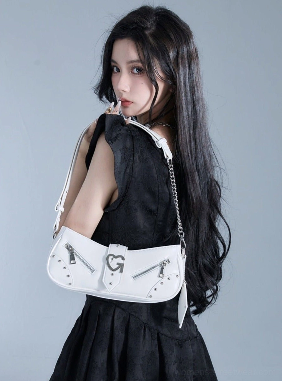 White chain strap baguette shoulder bag with smooth leather-look finish shown from the back with a black mini dress