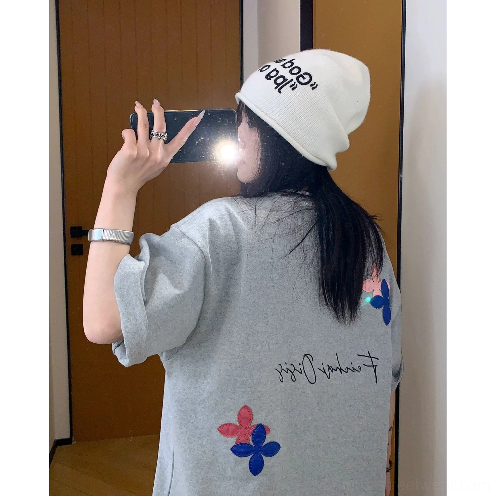 Y2K inspired oversized script T-shirt with playful flower graphics, relaxed sleeves, and a modern East Asian streetwear aesthetic