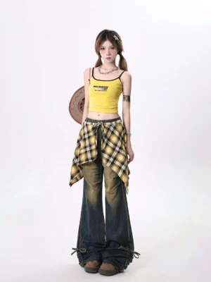 Full body model wearing plaid overlay wide leg jeans with yellow cropped top and cowboy hat in Korean Y2K streetwear style