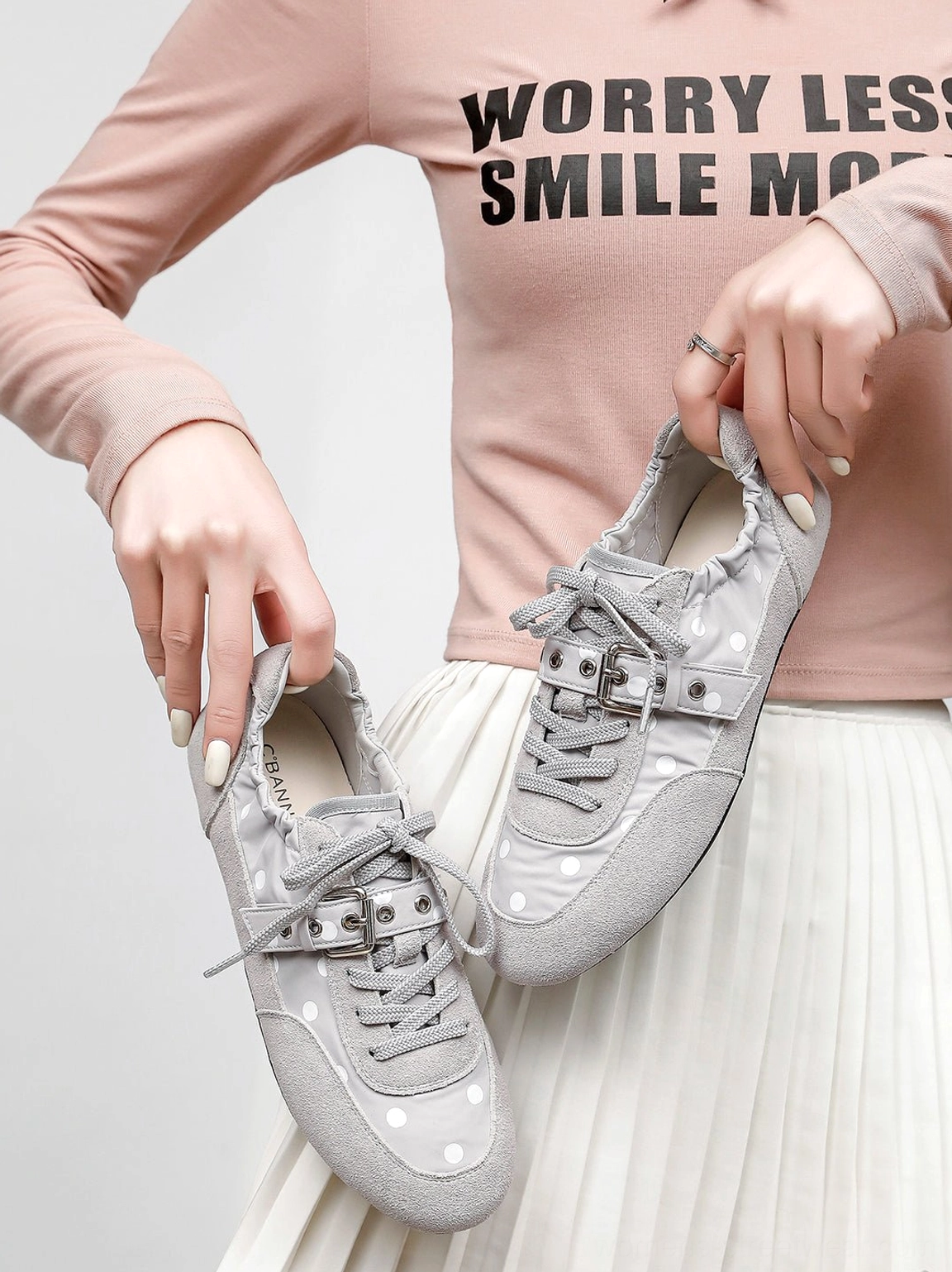 Y2K-inspired polka dot ballet sneakers with low-profile shape, lace-up closure, and decorative instep strap