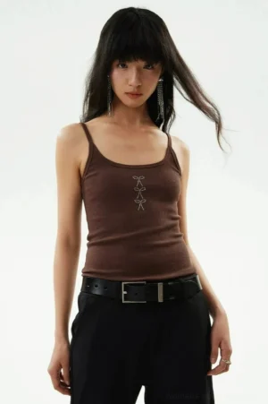 Brown Y2K rhinestone bow ribbed cami tank top styled with black wide-leg trousers and leather belt