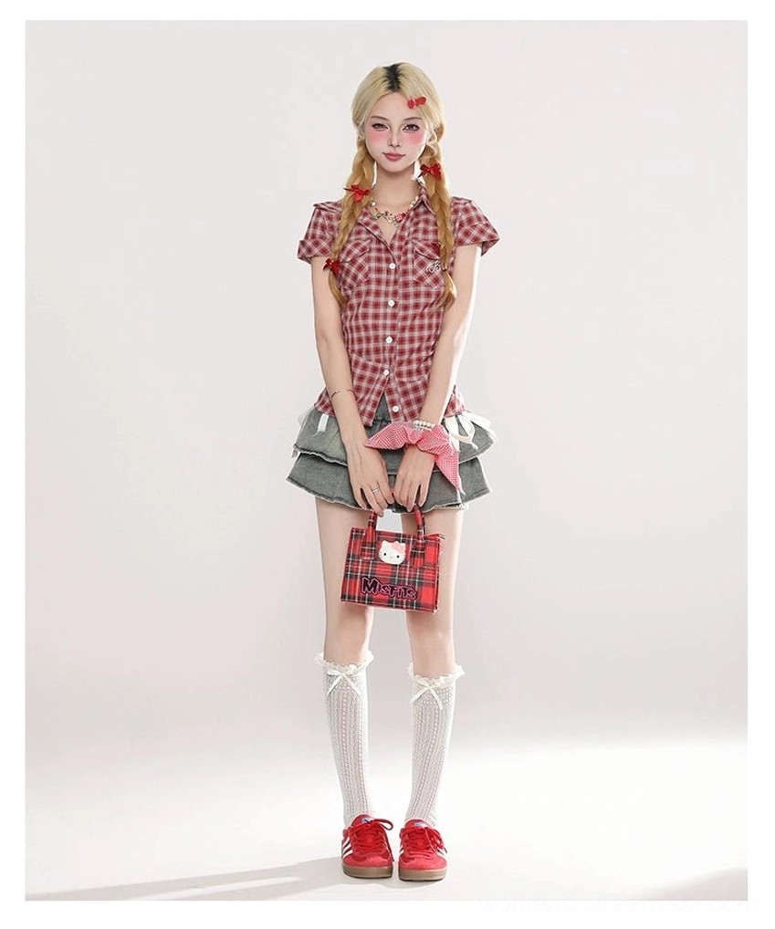 Full front view of a Y2K light blue ruffled mini skirt paired with a red plaid blouse, white lace knee socks, red flats, plaid handbag, and pink scrunchie