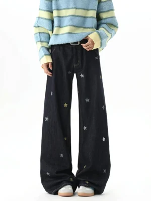 Front view of dark indigo Y2K star embroidery wide-leg jeans styled with a striped sweater and casual sneakers