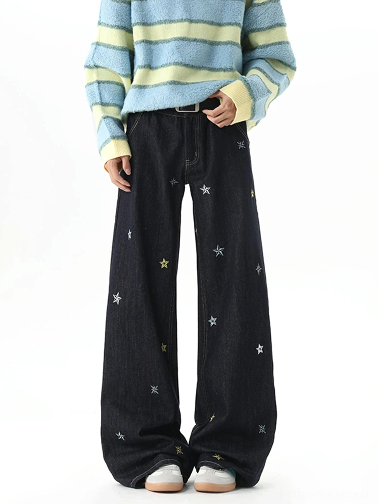Front view of dark indigo Y2K star embroidery wide-leg jeans styled with a striped sweater and casual sneakers