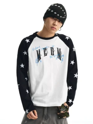 Male model styling a black and white star print raglan graphic long sleeve T-shirt with gray cargo pants, beanie, and utility bag