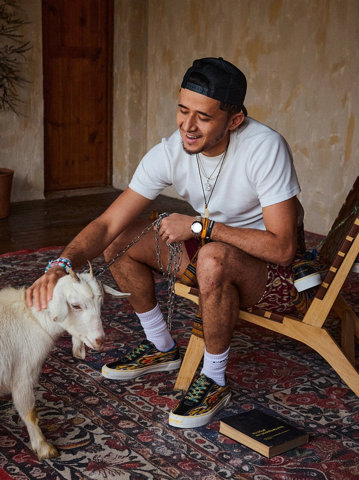 Close lifestyle view of colorful abstract canvas skate shoes styled with printed shorts and white crew socks