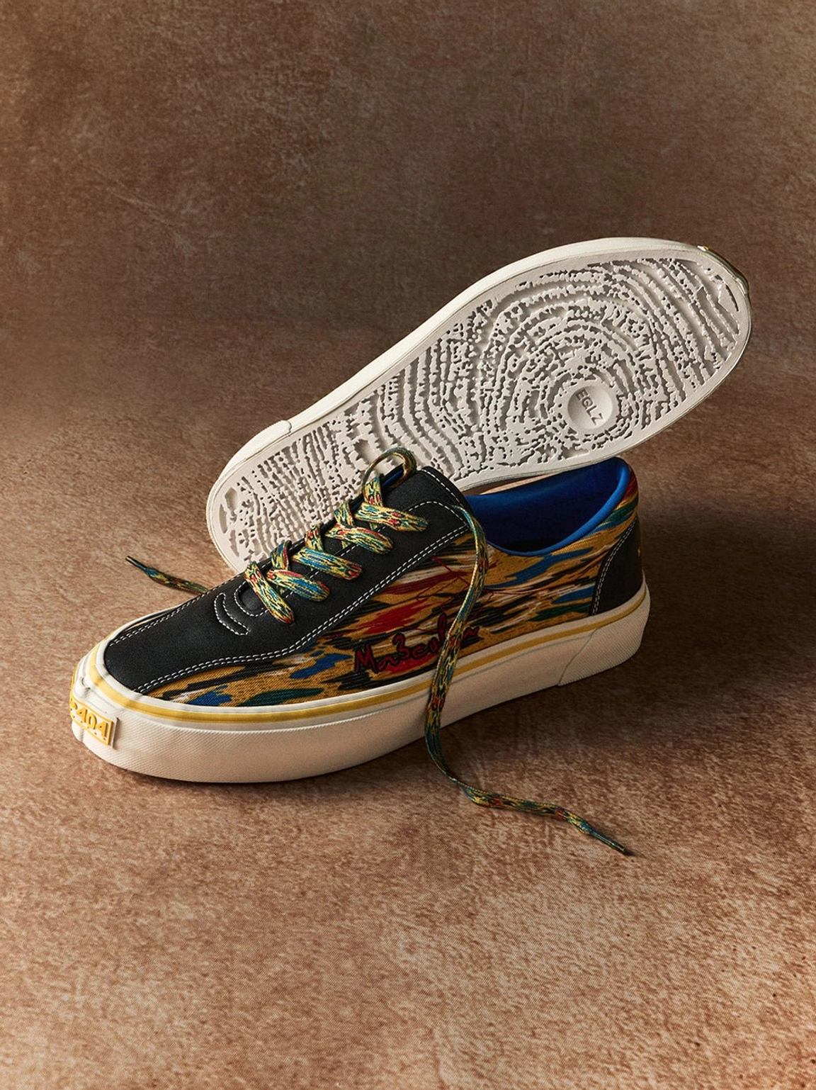 Yellow abstract print canvas skate shoes with colorful graphic upper and white rubber streetwear sole