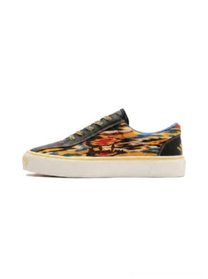 Yellow abstract print canvas skate shoes with colorful artwork, black microfiber toe trim, hidden laces, and white rubber sole