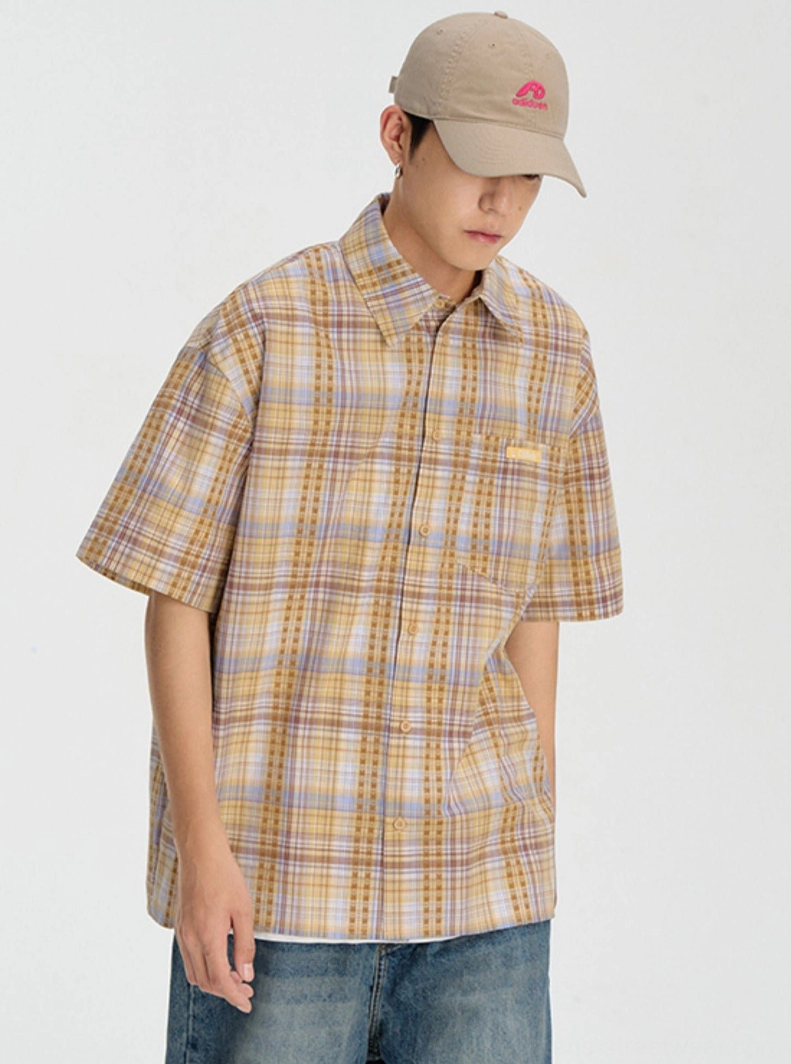 Yellow embroidered plaid short sleeve button-down shirt modeled with a beige baseball cap in a clean studio setting