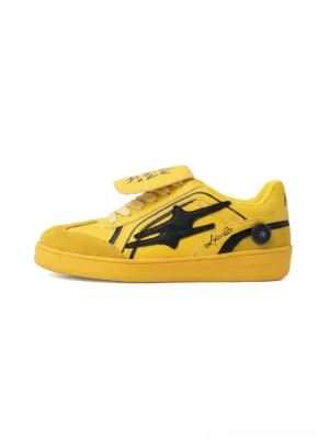 Front view of yellow graffiti retro trainer sneakers with black graphic overlays, contrast stitching, removable graphic tongue and vintage rubber sole