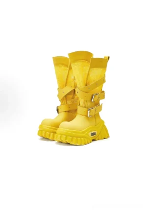 Bright yellow platform combat boots shown from the front three-quarter angle with breathable mesh upper, silver buckle straps, thick serrated sole, and structured mid-calf silhouette