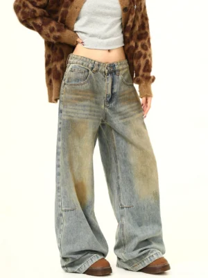Women's yellow mud dye distressed wide-leg jeans in a vintage washed high-waisted streetwear outfit front three-quarter view