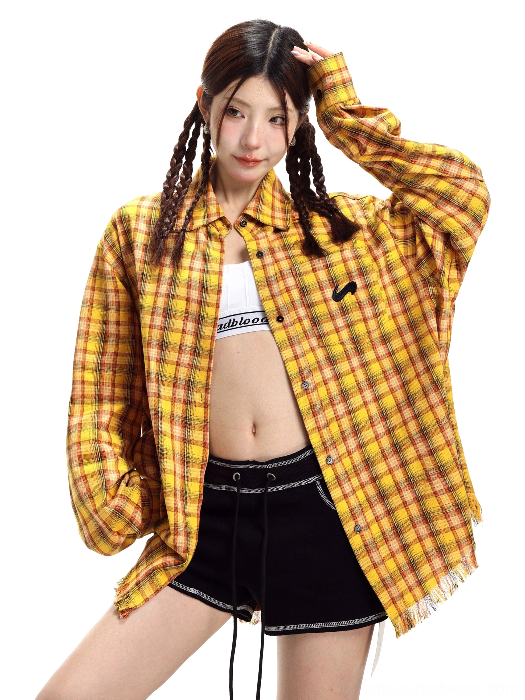 Yellow plaid oversized long-sleeve streetwear shirt styled on a female model with raw frayed hem classic collar black chest embroidery and Y2K Seoul fashion details