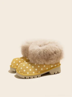 Pair of yellow polka dot faux fur cuff platform snow boots front three quarter view
