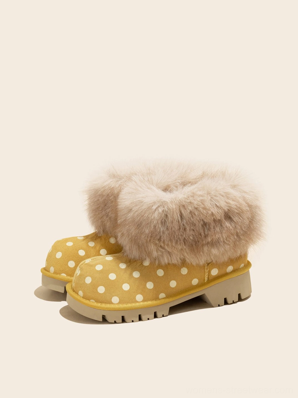 Pair of yellow polka dot faux fur cuff platform snow boots front three quarter view