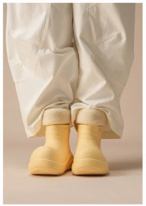 Yellow puff cloud winter platform boots with fleece cuffs styled with loose white wide-leg pants