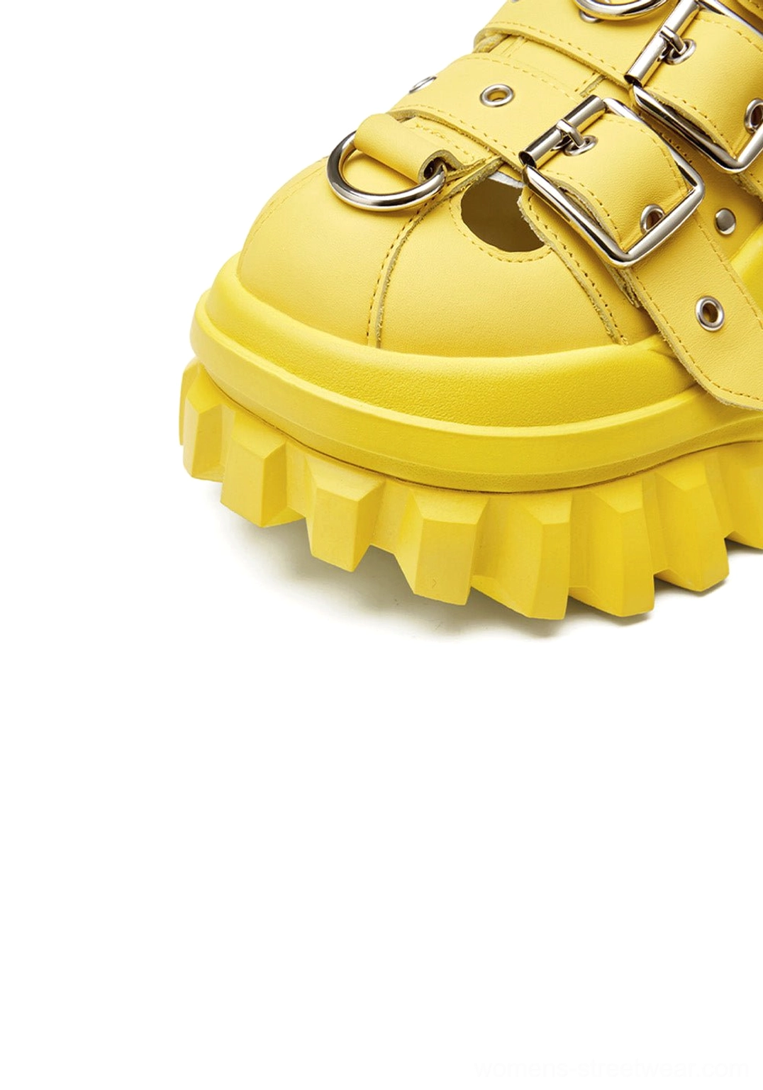 Front toe close-up of yellow punk triple-buckle platform sandals with textured platform outsole edge