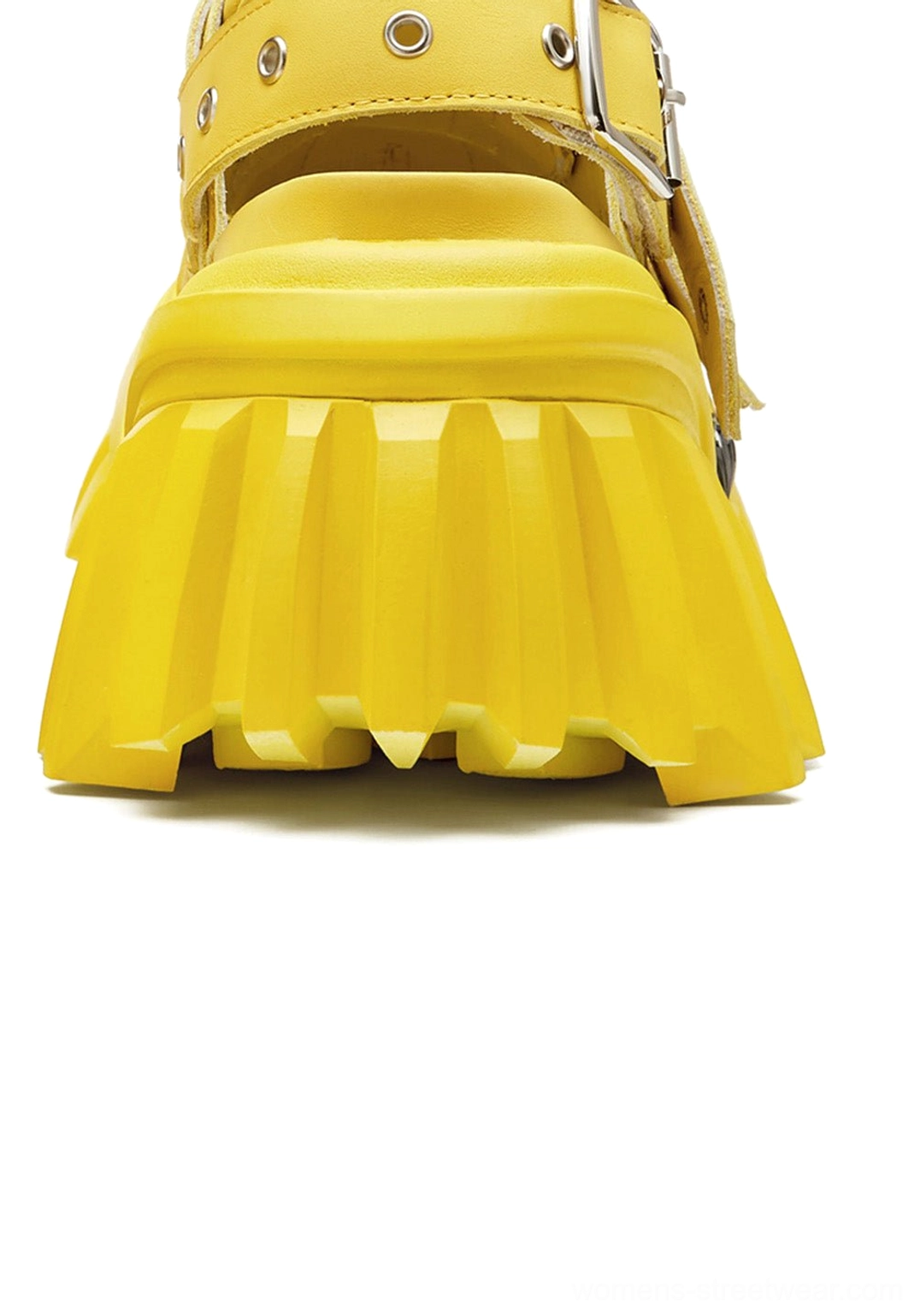 Rear heel view of yellow platform sandals showing back buckle strap and thick ridged lug sole