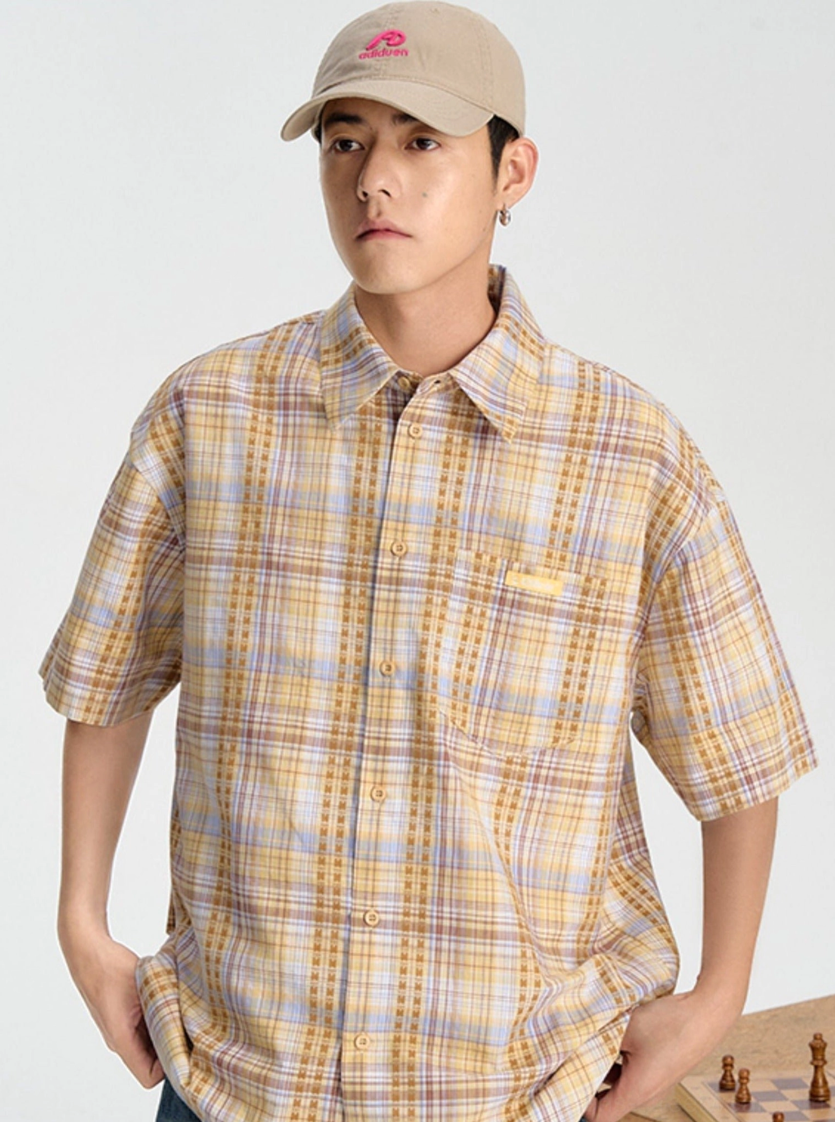 Yellow and purple embroidered plaid short sleeve shirt shown in a front full-body view with a relaxed button-down silhouette