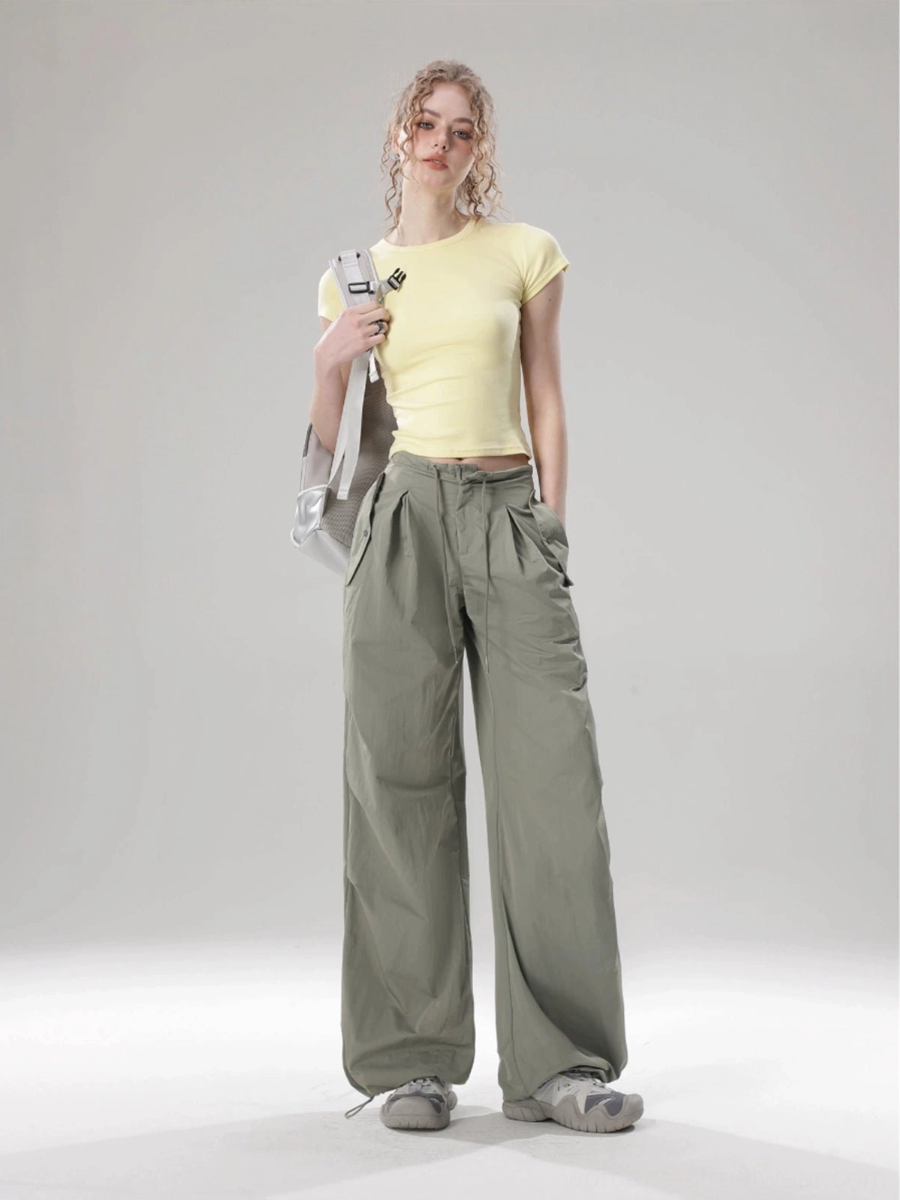 Yellow solid color fitted cropped top with crew neckline styled with olive green wide-leg cargo pants