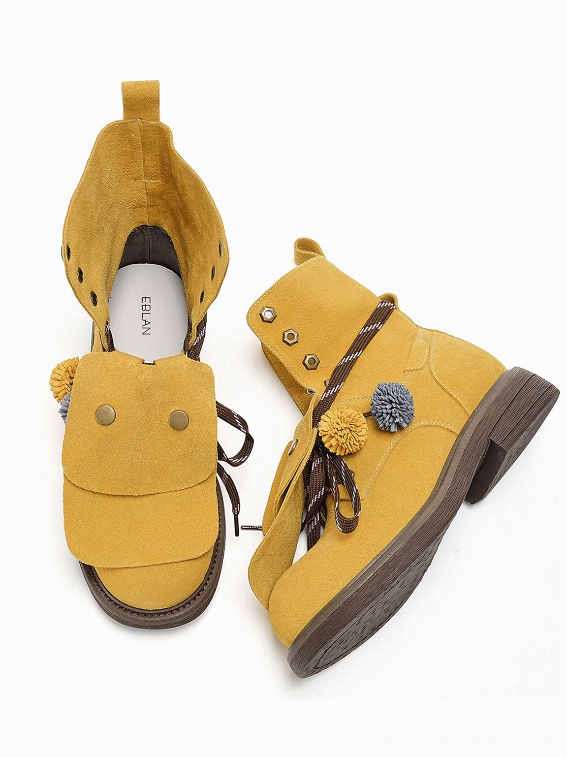 Yellow suede-look tassel lace-up ankle boots shown from an angled view with rounded toes, decorative flaps, and chunky low soles
