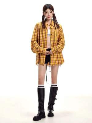 Yellow tartan plaid long-sleeve shirt worn open over a casual outfit with black knee-high boots and striped socks for Korean Y2K streetwear styling