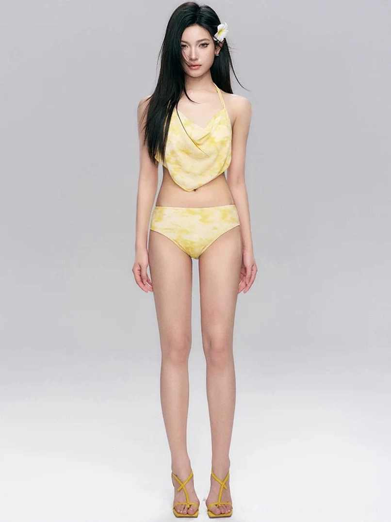 Full-body front view of a yellow tie-dye halter bikini with matching adjustable ruched mini skirt for Y2K beach and resort styling
