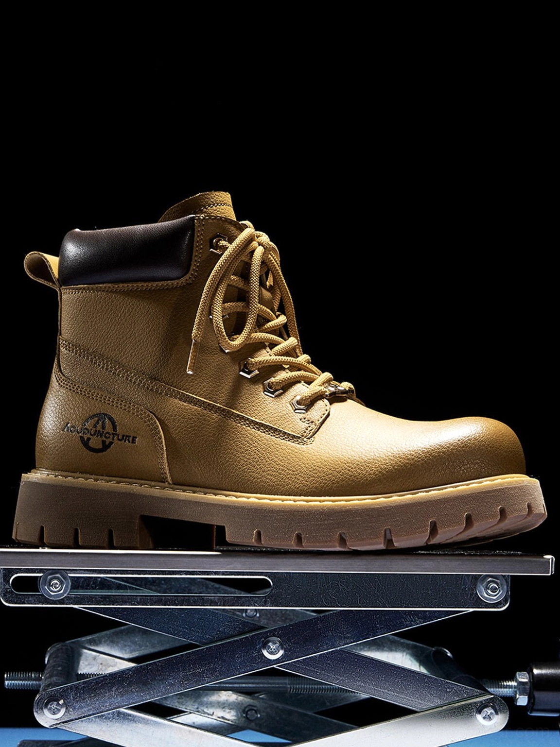 Flat lay front view zip-front tactical ankle boots black blue gradient background lug sole detail