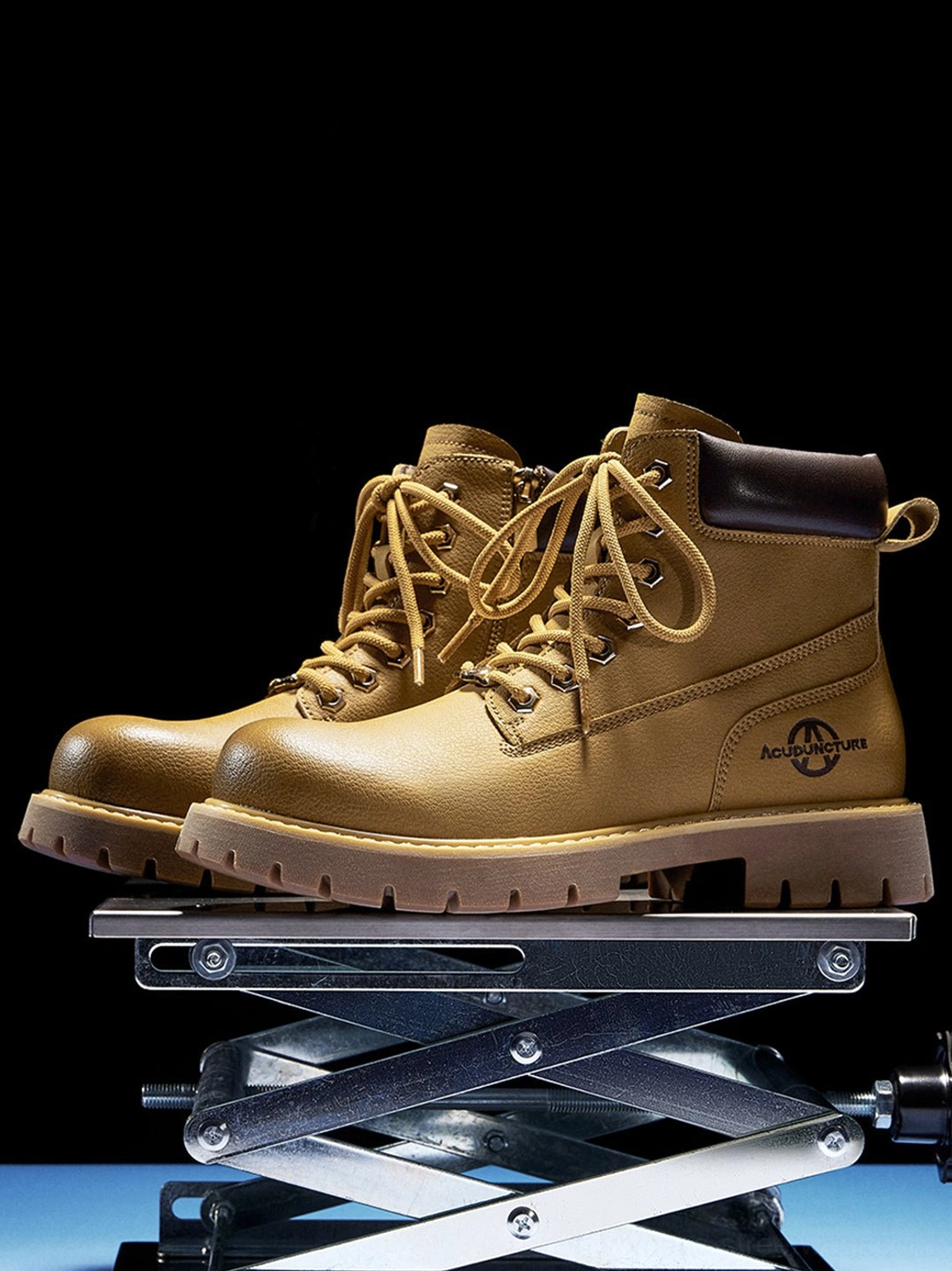 Pair tactical zip-front lug-sole ankle boots three quarter front view metal stand blue accent lighting studio